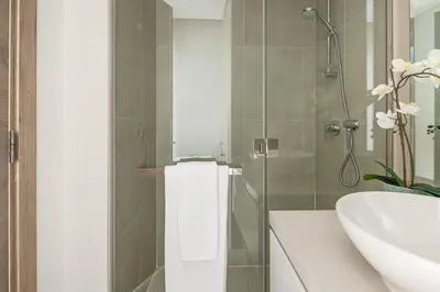 a bathroom with a sink and a toilet and a shower at Frank Porter - Studio One in Dubai