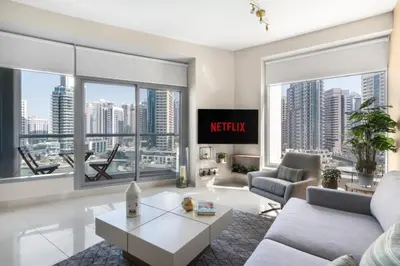 a living room with a view of a city at GuestReady - Marina View | Fairfield Tower in Dubai