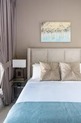 a bedroom with a white bed with a blue blanket at GuestReady - Marina View | Fairfield Tower in Dubai