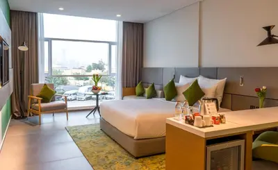 a hotel room with a bed and a living room at Al Khoory Courtyard Hotel in Dubai