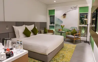 a bedroom with a bed and a desk with a chair at Al Khoory Courtyard Hotel in Dubai