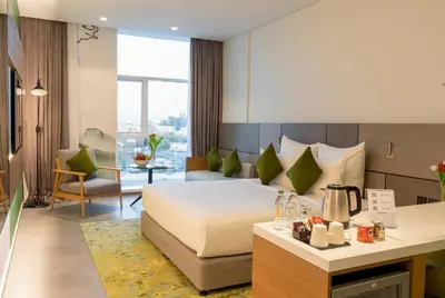 a hotel room with a bed and a living room at Al Khoory Courtyard Hotel in Dubai
