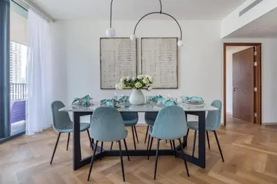 a dining room with a table and chairs at Frank Porter - BLVD Heights T1 in Dubai