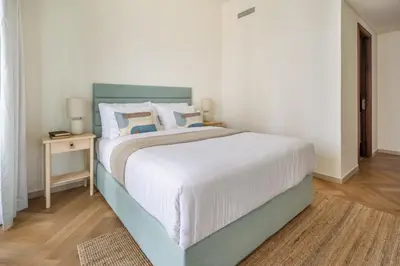 a bedroom with a large bed and a table at Frank Porter - BLVD Heights T1 in Dubai
