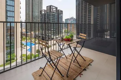 a balcony with a table and chairs and a view of a city at Frank Porter - BLVD Heights T1 in Dubai