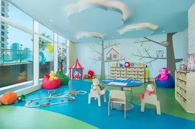 a childs room with a play area with a table and chairs at Damac Maison Prive Deluxe Studio with Water Canal View in Dubai