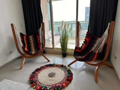 two chairs and a rug in a room with a window at Nice 2 bedroom apartment-minimum 5 night in Dubai