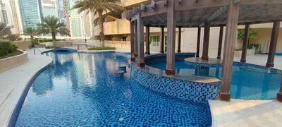 a large swimming pool with blue tiles in a building at Nice 2 bedroom apartment-minimum 5 night in Dubai