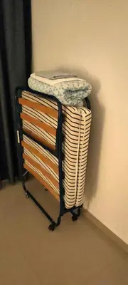 a towel rack with a pile of towels on it at Nice 2 bedroom apartment-minimum 5 night in Dubai
