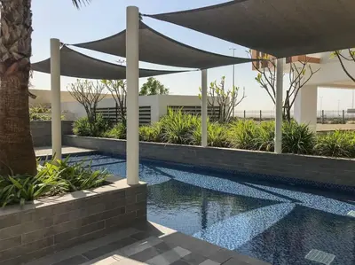 a canopy over a swimming pool in a building at Frank Porter - DAMAC Celestia in Dubai