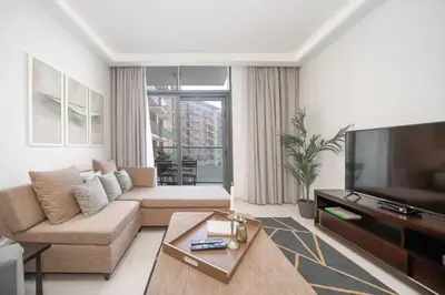 a living room with a couch and a flat screen tv at Frank Porter - DAMAC Celestia in Dubai
