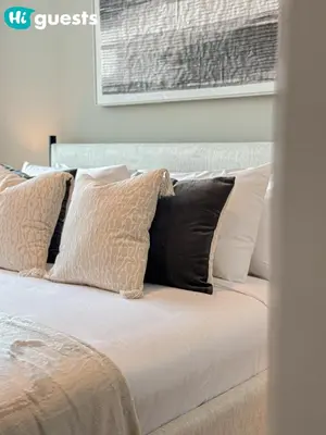 a bed with black and white pillows on it at HiGuests - Exceptional Apt with Furnished Terrace By the Sea in Dubai
