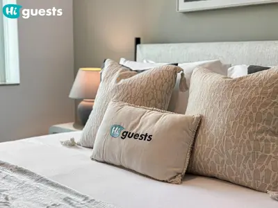 a row of pillows on a bed with the words guest at HiGuests - Exceptional Apt with Furnished Terrace By the Sea in Dubai