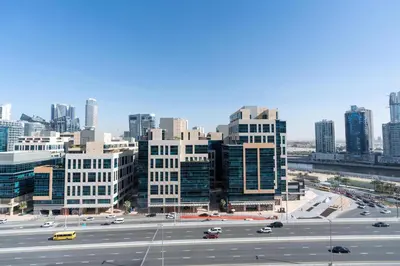 a view of a city with cars on a highway at White Sage - Elite Residence 1 bedroom in Dubai