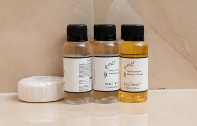 three bottles of essential oils sitting on a shelf at White Sage - Elite Residence 1 bedroom in Dubai