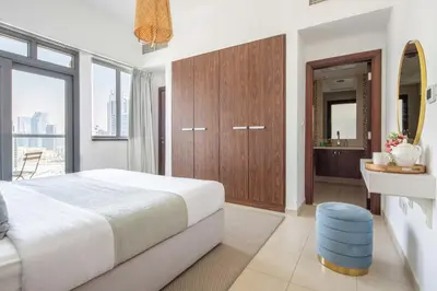 a bedroom with a large bed and a bathroom at Frank Porter - Executive Tower F in Dubai