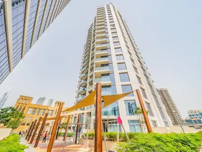 a tall building with a sculpture in front of it at Charming Tropical Apartment Minutes To Dubai Mall in Dubai
