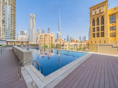 a rooftop pool with a view of the city at Charming Tropical Apartment Minutes To Dubai Mall in Dubai