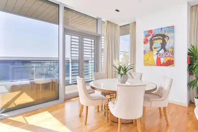 a dining room with a table and chairs at Premium 2+1 BR condo in the heart of Bluewaters Island in Dubai