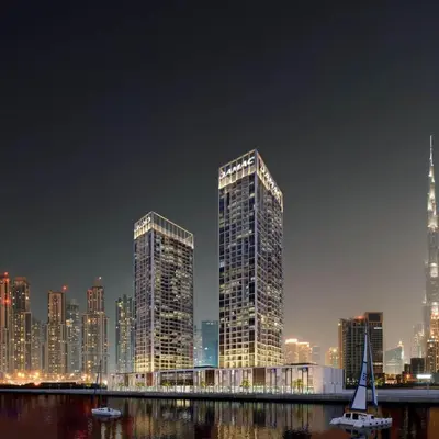 two tall skyscrapers in a city at night at DAMAC MAISON PRIVE in Dubai