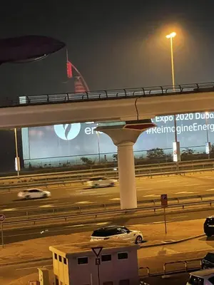 a car driving on a highway at night at AlBarsha 1 Hostel by PHM in Dubai