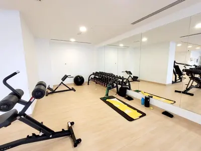 a gym with several treadmills and exercise bikes at Bloom Height Tower in Dubai
