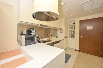 a kitchen with a white counter top and a microwave at FAHH - Spacious Studio in Emaar Fashion Avenue in Dubai