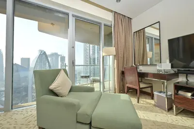a living room with a couch and a desk at FAHH - Spacious Studio in Emaar Fashion Avenue in Dubai