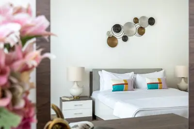 a bedroom with two beds with pans on the wall at The Smart Concierge - Amna Tower in Dubai