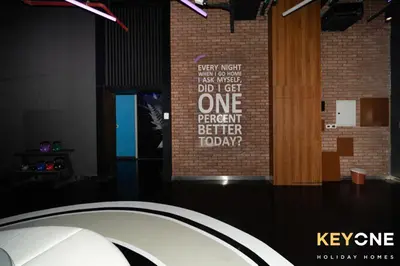 a sign on a brick wall with words on it at Modern & Stylish Studio in JVT in Dubai