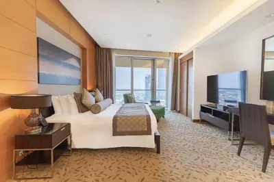 a hotel room with a bed and a flat screen tv at FAHH - Amazing Studio in Emaar Fashion Avenue in Dubai