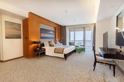 a hotel room with a bed and a television at FAHH - Amazing Studio in Emaar Fashion Avenue in Dubai