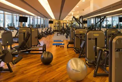 a gym with lots of treadmills and exercise equipment at FAHH - Amazing Studio in Emaar Fashion Avenue in Dubai