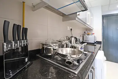 a kitchen with pots and pans on a stove at Spacious Apartment with Balcony Near Dubai Mall in Dubai