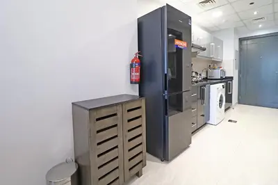 a kitchen with a large refrigerator and a stove at Spacious Apartment with Balcony Near Dubai Mall in Dubai
