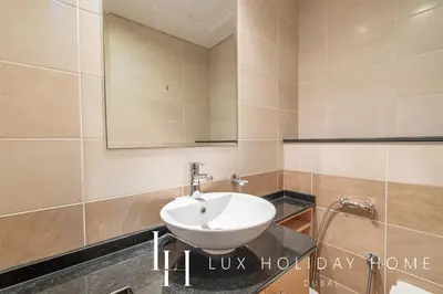 a bathroom with a sink and a mirror at LUX The Sky View Suite Dubai Marina in Dubai