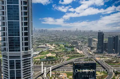 an aerial view of a city with a tall building at LUX The Sky View Suite Dubai Marina in Dubai