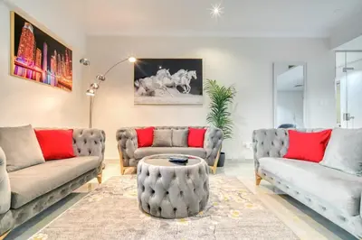 a living room with two couches and a table at The Marina PENTHOUSE near JBR 46th Floor in Dubai