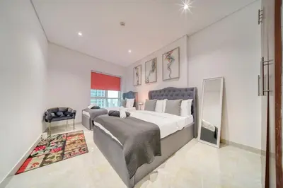 a bedroom with a large bed and a rug at The Marina PENTHOUSE near JBR 46th Floor in Dubai