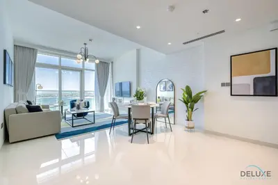a living room with a table and chairs at Idyllic 1BR at Sunrise Bay Tower 1 Emaar Beachfront Dubai Marina by Deluxe Holiday Homes in Dubai