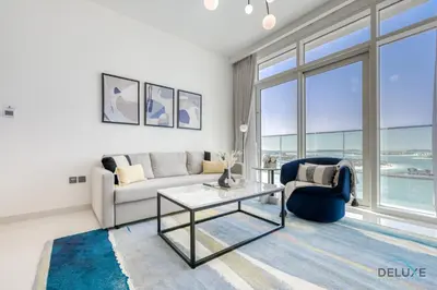a living room with a couch and a table at Idyllic 1BR at Sunrise Bay Tower 1 Emaar Beachfront Dubai Marina by Deluxe Holiday Homes in Dubai