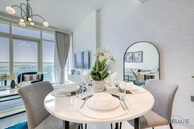 a dining room with a table and chairs and a mirror at Idyllic 1BR at Sunrise Bay Tower 1 Emaar Beachfront Dubai Marina by Deluxe Holiday Homes in Dubai