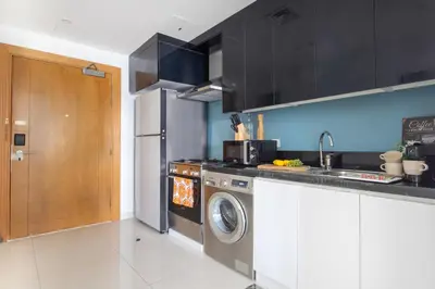 a kitchen with a sink and a washing machine at Frank Porter - Capital Bay Tower B in Dubai