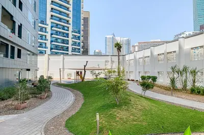 a walkway in the middle of a city with buildings at Frank Porter - Capital Bay Tower B in Dubai