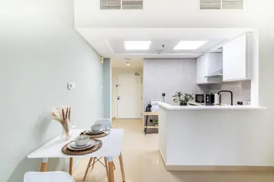 a kitchen and dining room with a table and chairs at GuestReady - Jumeirah Skyline Apartment in Dubai