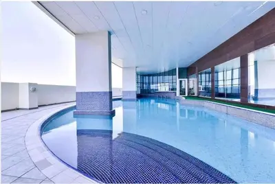 a large swimming pool in a large building at GuestReady - Jumeirah Skyline Apartment in Dubai