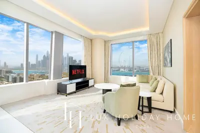 a living room with a couch and a tv at LUX Iconic Views at The Palm Tower Suite 2 in Dubai