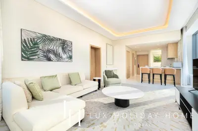 a living room with a couch and a table at LUX Iconic Views at The Palm Tower Suite 2 in Dubai
