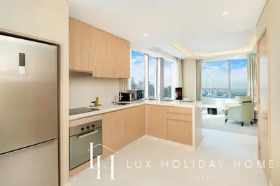 a kitchen with a view of a living room at LUX Iconic Views at The Palm Tower Suite 2 in Dubai