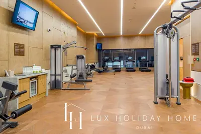 a gym with exercise equipment in a room at LUX Iconic Views at The Palm Tower Suite 2 in Dubai